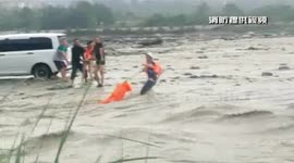 Firefighters in southern China rescue passengers after their car became trapped in flooded river