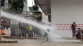 Moment journalist gets targeted by water cannon during Hong Kong security law protest