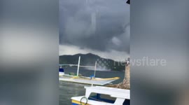 Waterspout sweeps through beach harbour in the Philippines