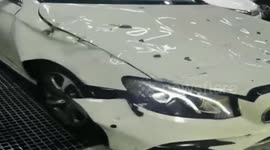 Tiles fall off building and hit car seconds after man runs past in China