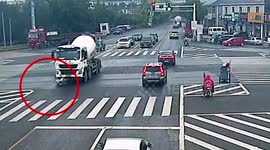 Mixer truck drags elderly Chinese woman along road after she runs red light