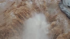 Spectacular footage showcases the world's largest yellow waterfall during flood season