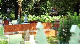 Resident in Palembang are fishing togather in the middle of on cemeteries