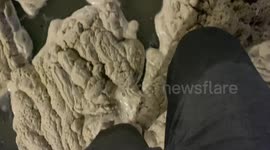 Newport Beach Dangerous Flooding. Brown sea foam left behind for blocks.