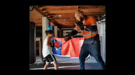 7 year old brother and sister doing pads with dad