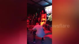 Energetic grandfather dances on stage with coyote dancer