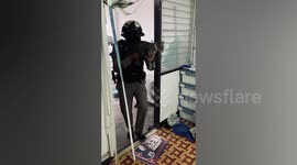 Policeman uses pet cat like toy gun