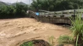 Ancient bridge collapses into overflowing river in eastern China
