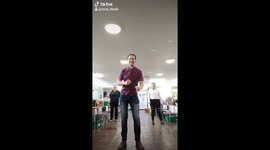 Priest leads a Tik Tok at a foodbank with a carrot