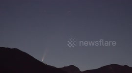 Comet neowise rises over Swiss mountain