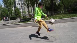 Chinese boy shows off impressive soccer skills by juggling football while skipping
