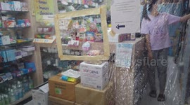 Pharmacy uses large plastic sheet covering counter to protect against Covid-19
