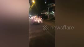 Young boy rides motorcycle trailer in Cambodia