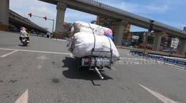 Overloading their motorcycles isn't a problem for these Vietnamese bikers