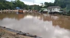 Road submerged after heavy rain causes flash floods in northern Thailand