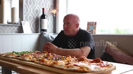 A deli is offering up a monstrous 8,000 calorie pizza which has left even the most prolific competitive eaters struggling to gobble the 1 METRE long pie up