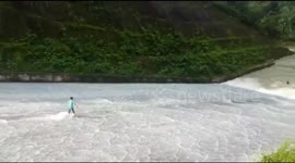 Dam-surfing daredevils at reservoir in Indonesia