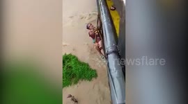 Fire and emergency team rescue two people stranded in flooded river in Northeastern India