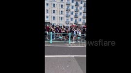 Hundreds of BLM supporters march through Brighton in masks while observing social distancing