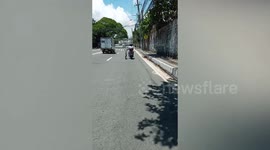 Motorbiker rides home while dragging bicycle on the road