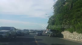 Monkey hitches a ride on passing car