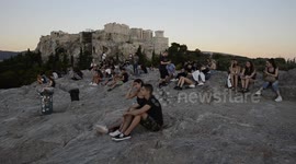 Tourists underneath the Acropolis in Athens Greece