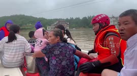 Firefighters rescue 2,000 stranded people after burst dam floods village