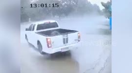 Car spins out of control on wet road and hits utility pole in Thailand