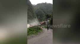 Daredevil calmly takes photos on site metres away from landslide in central China