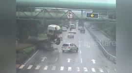 Out-of-control truck narrowly misses car after smashing through embankment in China