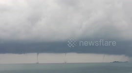 Spectacular triple waterspout forms off the coast of the Philippines
