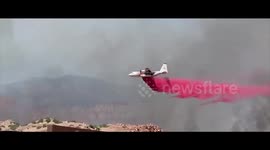 Plane drops fire retardant on fire caused by fireworks in Utah