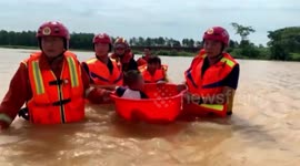 Firefighters use basin to transport sick nine-month-old to hospital through deep floodwater