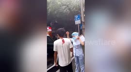 Chinese man calmly walks to ambulance with knife stuck in his head
