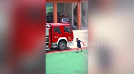 Excited fireman dances while putting extinguishers into fire engine in China