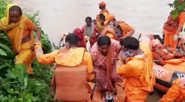 Disaster response teams rescue woman and children trapped by floods in east India