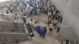 Newsflare Edit - Moment lone woman is attacked with umbrella at Hong Kong station by thugs in white shirts