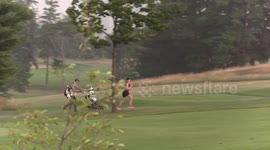 Golfers run for cover during surprise storm in Canada, as lightning, heavy rain hits city