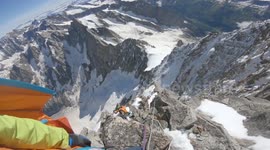 Base jumper leaps from the top of the peak of mountain