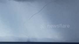 Waterspout forms across beach in the Philippines