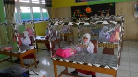 School installs plastic cubicles for students to curb spread of COVID-19