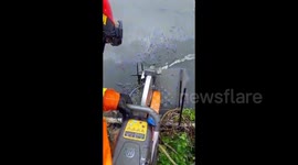 Team of firefighters cut open metal pipe to rescue trapped kitten in Indonesia