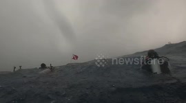 Scuba diver off Florida swims in stormy seas while sharks circle beneath his feet