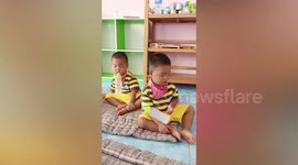 Toddler twins struggle to stay awake while drinking bottles