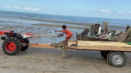 Boy drives tractor to help family collect ocean trash in Cambodia