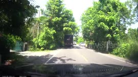 Heart-stopping moment cyclist is inches from being crushed by overtaking truck
