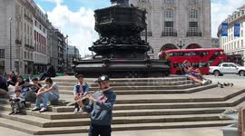 Talented Young Musician Junior Marvel Plays The Flute in Piccadilly