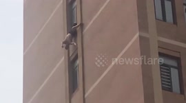 Firefighters rescue elderly man hanging upside down out of 10th-floor window in China