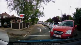 Close call during UK driving lesson as red car pulls out in front of learner
