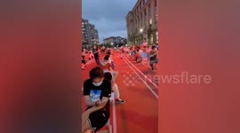 Chinese citizens line up on school playground waiting for coronavirus testing
